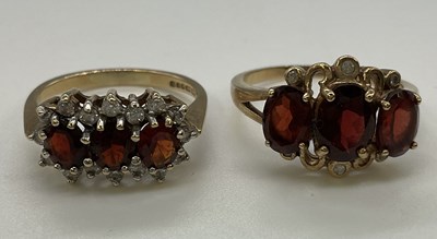 Lot 1236 - Two 9ct yellow gold garnet set dress rings,...