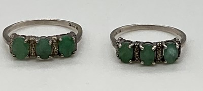 Lot 1255 - A pair of 9ct white gold dress rings, combined...