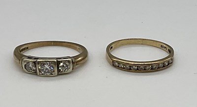 Lot 1217 - A 9ct yellow gold three stone diamond ring and...