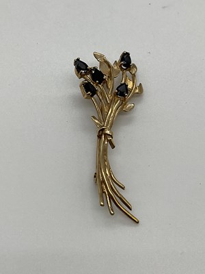 Lot 1261 - A 9ct yellow gold sapphire set leaf brooch,...