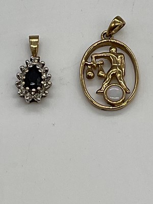 Lot 1271 - A 9ct yellow gold sapphire and diamond pendant...