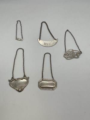 Lot 1075 - Five sterling silver bottle labels, four...