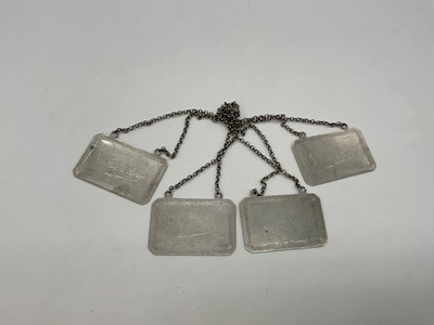 Lot 1111 - A set of four white metal engraved bottle...