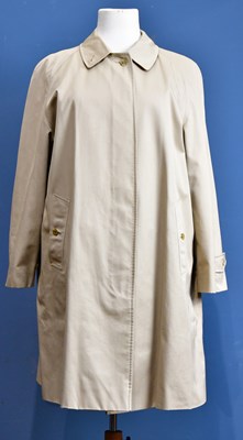 Lot 992 - BURBERRY; a beige gabardine short raincoat...