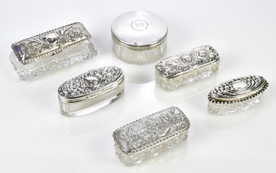 Lot 2556 - Seven glass dressing table jars with...