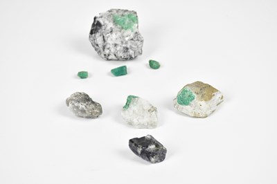 Lot 2186 - A group of five rough emeralds, together with...