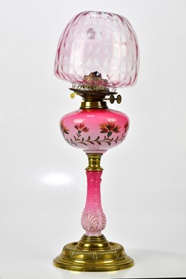 Lot 1591 - A late Victorian cranberry and milk glass oil...