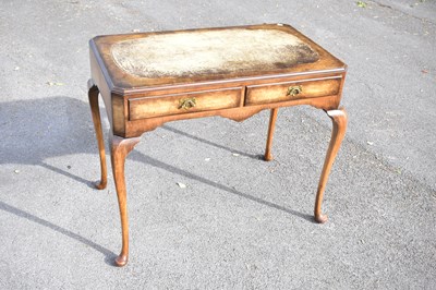 Lot 2520 - A 1930s walnut writing table with leather...