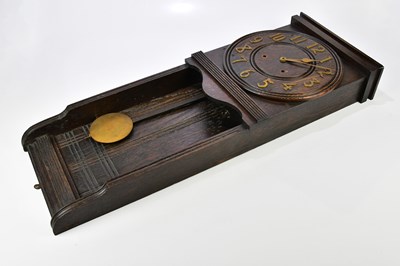 Lot 2329 - An Arts and Crafts oak wall clock, the dial...