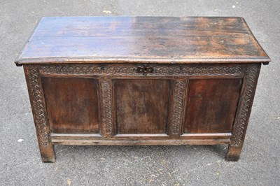 Lot 2375 - An 18th century carved oak coffer, with three...
