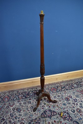 Lot 2440 - A carved mahogany standard lamp on ball and...
