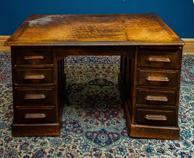 Lot 2360 - A 1920s/30s oak knee hole twin pedestal desk,...