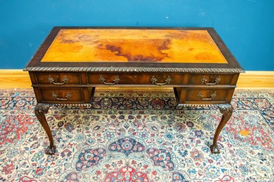Lot 2358 - A 1950s mahogany kneehole desk with tooled...