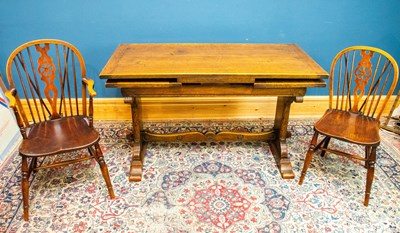 Lot 2347 - A reproduction oak draw-leaf dining table with...