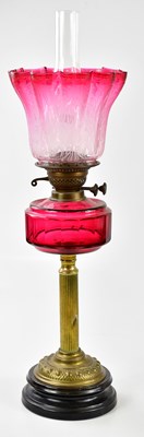 Lot 1182 - A Victorian oil lamp, the fluted cranberry and...