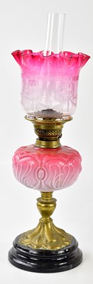 Lot 1183 - A Victorian oil lamp, the cranberry and clear...