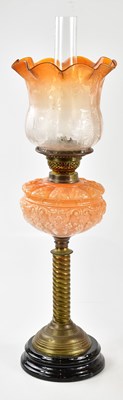 Lot 1188 - A late Victorian oil lamp, the orange tinted...