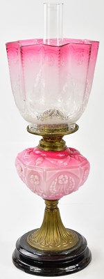 Lot 1190 - A late Victorian oil lamp, the cranberry and...