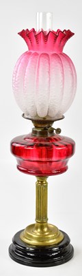Lot 1197 - A Victorian oil lamp, the cranberry and clear...