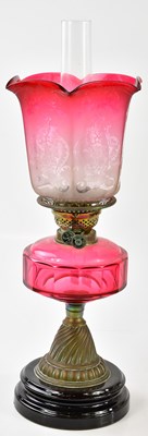 Lot 1179 - A late Victorian oil lamp, the faceted...