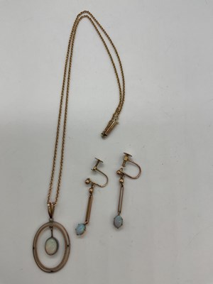 Lot 1227 - A 9ct yellow gold chain suspending a yellow...