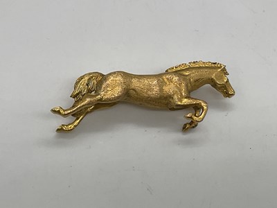 Lot 1168 - A 9ct yellow gold brooch modelled as a leaping...