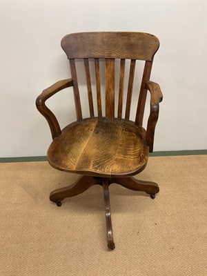 Lot 446 - An American oak adjustable swivel chair.