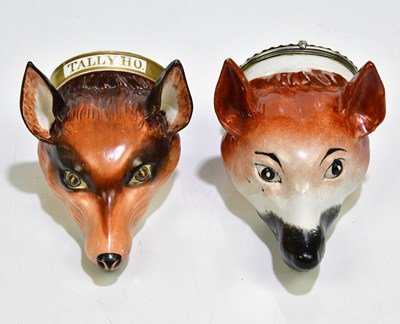 Lot 1496 - Two 19th century stirrup cups modelled as fox...