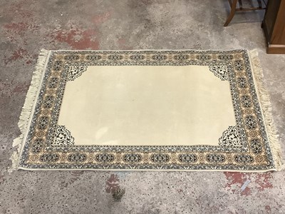 Lot 2282 - A modern rug on gold/brown ground. 140x200cm