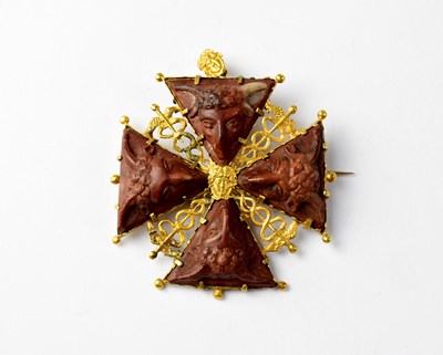 Lot 907 - A mid-19th century lava and gilt brooch