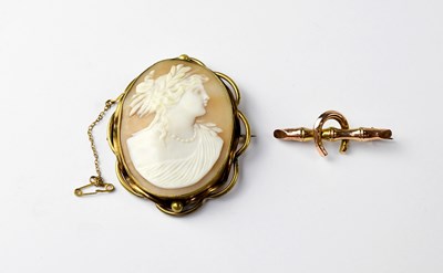 Lot 903 - A yellow metal brooch in the form of a branch and central horseshoe