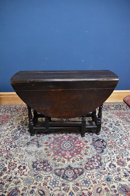 Lot 2382 - An 18th century oak drop leaf gateleg dining...