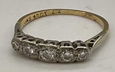 Lot 1231 - An 18ct yellow gold and diamond five stone...