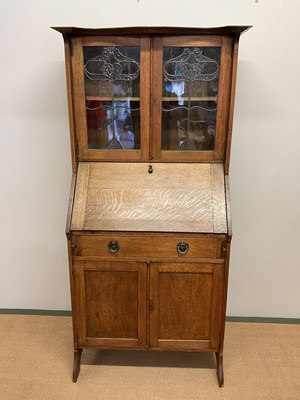 Lot 530 - An oak Arts and Crafts bureau book case,...