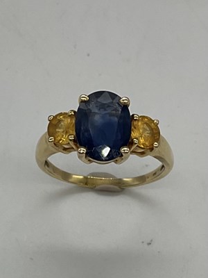 Lot 1196 - A 14ct yellow gold three stone dress ring,...