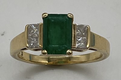 Lot 1173 - An 18ct yellow gold emerald and diamond ring,...