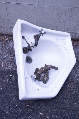Lot 2311 - A vintage white glazed corner sink with an...