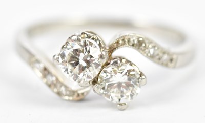 Lot 1119 - A platinum and diamond crossover ring, each...