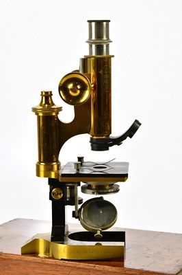 Lot 1557 - A cased lacquered brass monocular microscope,...