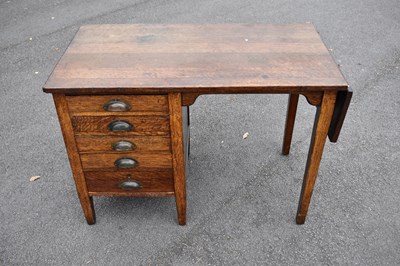 Lot 2525 - A 1920s oak kneehole desk with five drawers to...