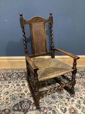 Lot 2580 - An early 20th century oak framed rush-seated...