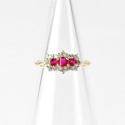 Lot 844 - An 18ct yellow gold ring set with three rubies...