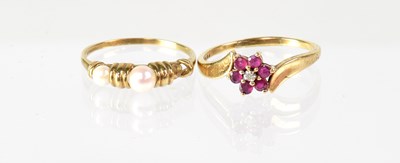 Lot 829 - A 10ct gold cluster ring set with red stones...