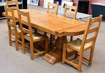 Lot 2361 - A modern solid oak refectory dining table on...