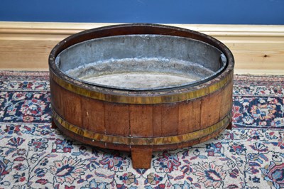 Lot 2481 - A brass bound oak planter, length 61cm.
