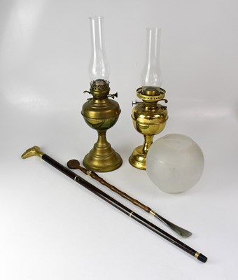 Lot 73 - Two brass oil lamps with funnels, one with an...