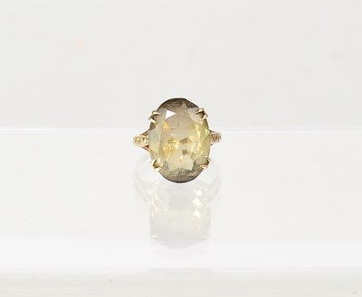 Lot 872 - A 9ct gold dress ring set with smoky quartz in...