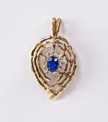 Lot 938 - A 9ct gold openwork oval pendant, set with...