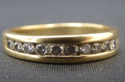 Lot 1009 - A modern 18ct gold half eternity ring