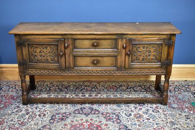 Lot 2634 - A reproduction oak sideboard with two central...